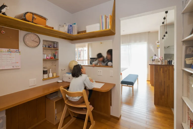 リビングとつながる造作カウンター付きスタディコーナーで学習する子ども